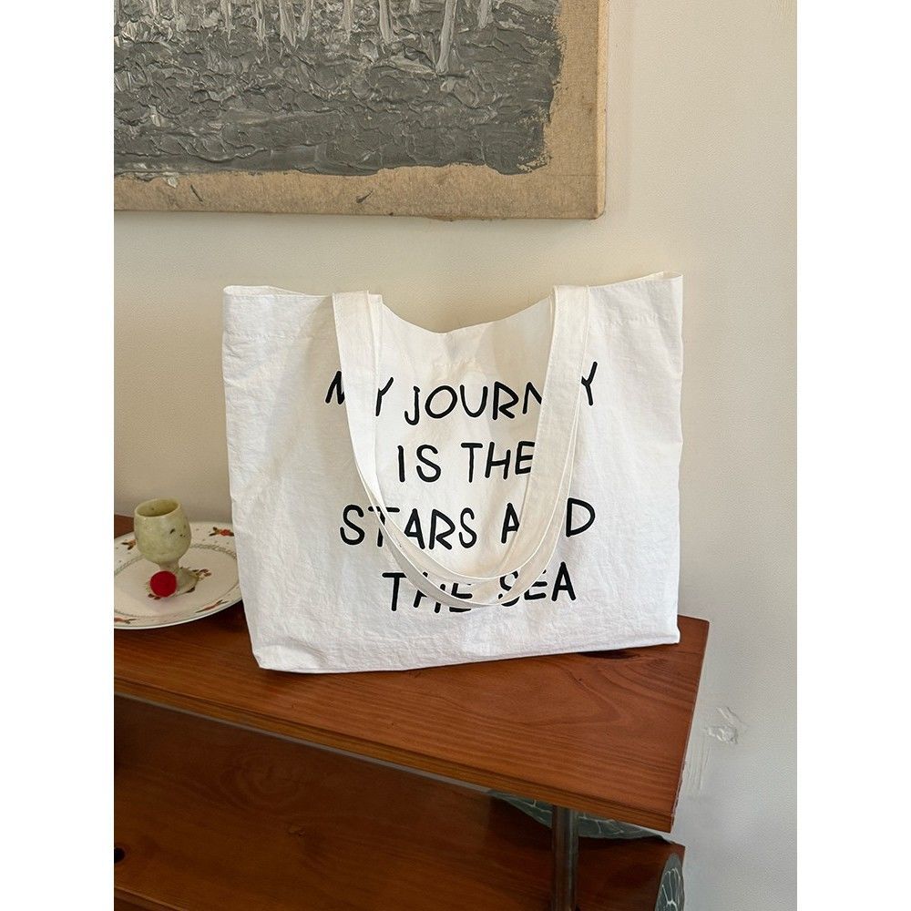 2025 new autumn and winter large capacity canvas bag, women's new lazy style work commuting shoulder bag, niche versatile tote bag