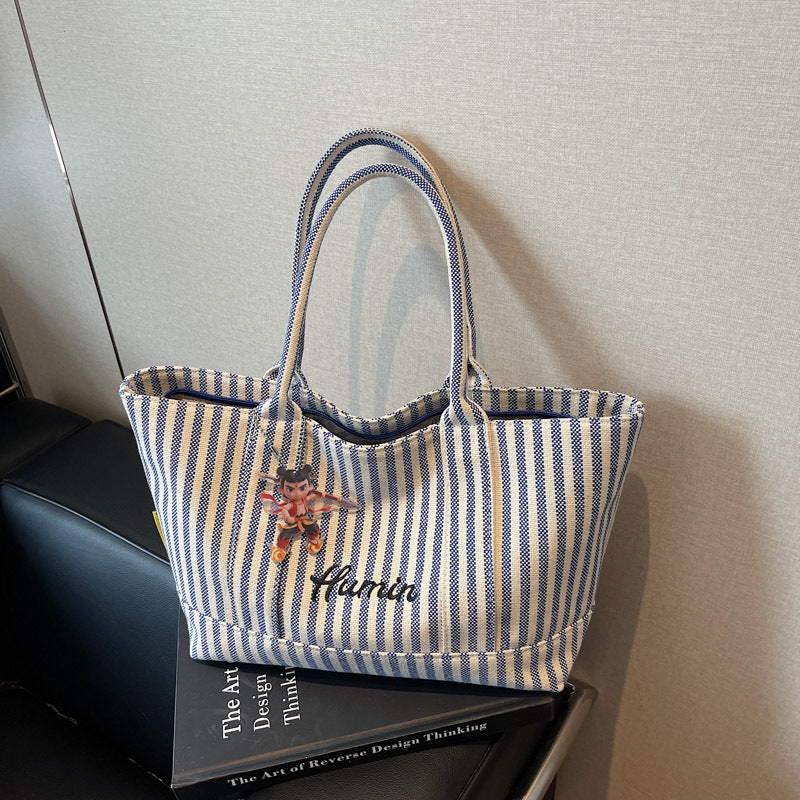 Striped canvas handbag for women in spring and summer 2025, large capacity tote bag, commuting shoulder bag, travel bag