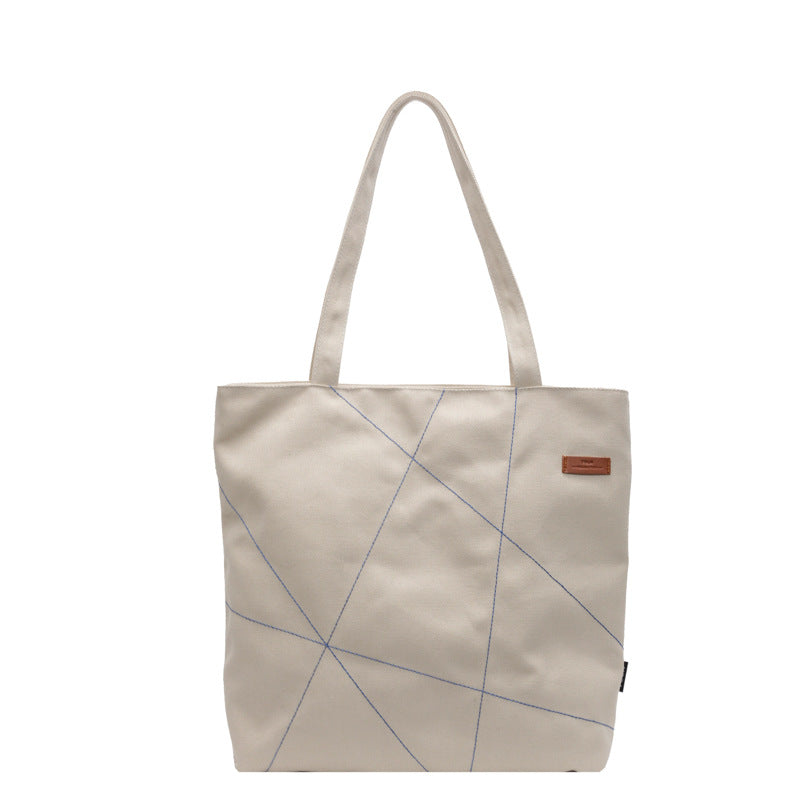 Large capacity tote bag for women in autumn 2025 with new stitching design, shoulder bag, fashionable commuting bag, versatile and trendy canvas bag