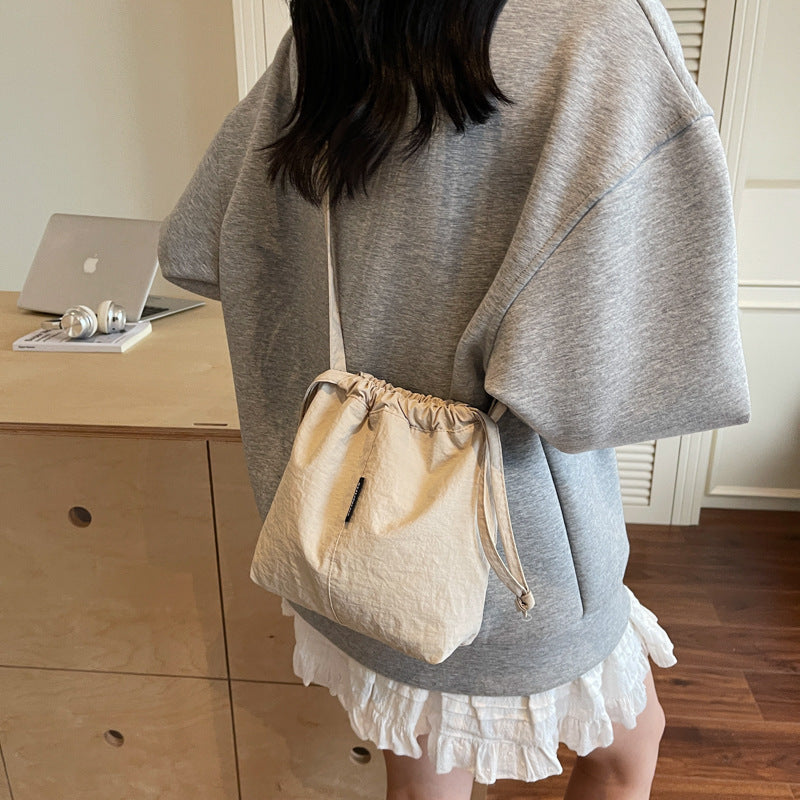 Summer casual versatile drawstring Oxford cloth bucket bag, women's 2025 new niche artistic crossbody bag, mobile phone bag