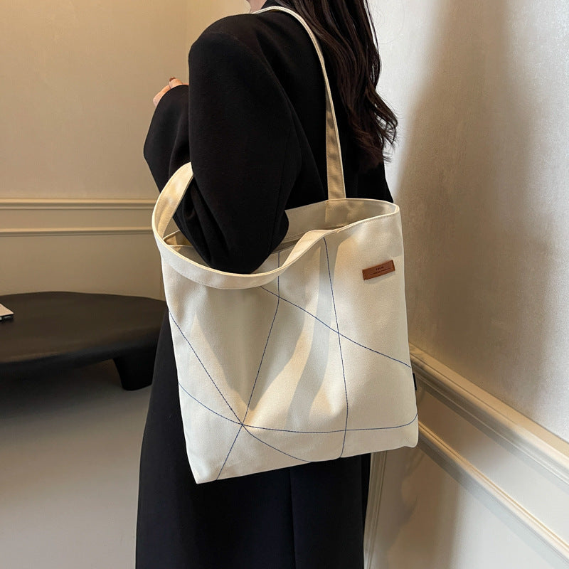 Large capacity tote bag for women in autumn 2025 with new stitching design, shoulder bag, fashionable commuting bag, versatile and trendy canvas bag