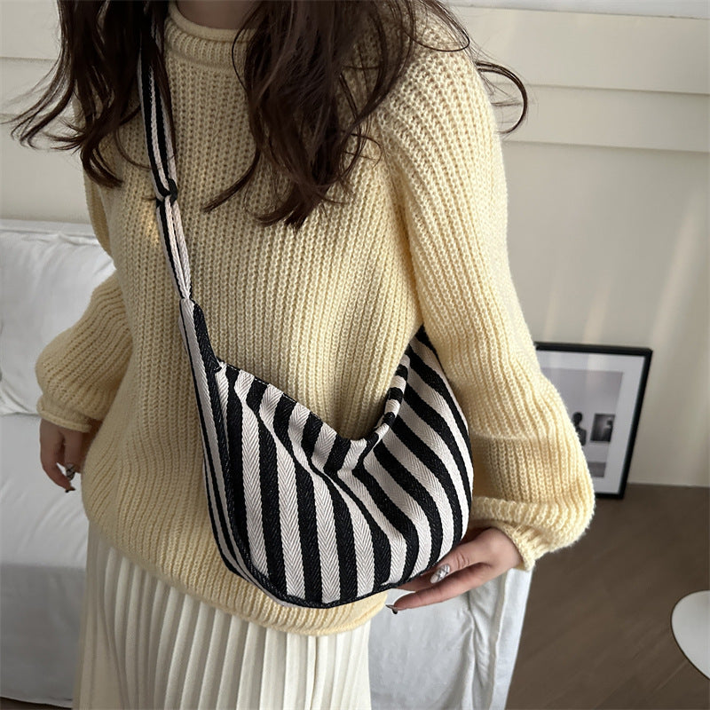 Korean version of small fresh contrasting striped shoulder bag, large capacity tote bag, new single shoulder armpit bag, artistic crossbody bag
