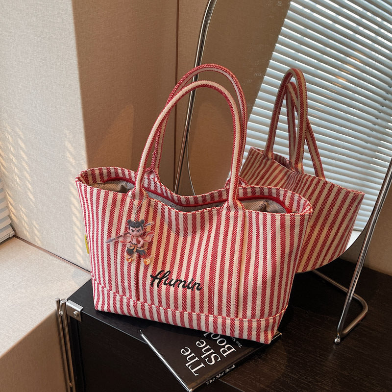 Striped canvas handbag for women in spring and summer 2025, large capacity tote bag, commuting shoulder bag, travel bag
