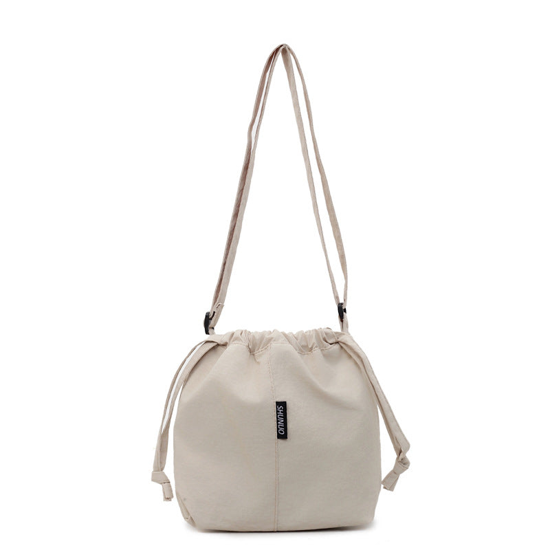 Summer casual versatile drawstring Oxford cloth bucket bag, women's 2025 new niche artistic crossbody bag, mobile phone bag