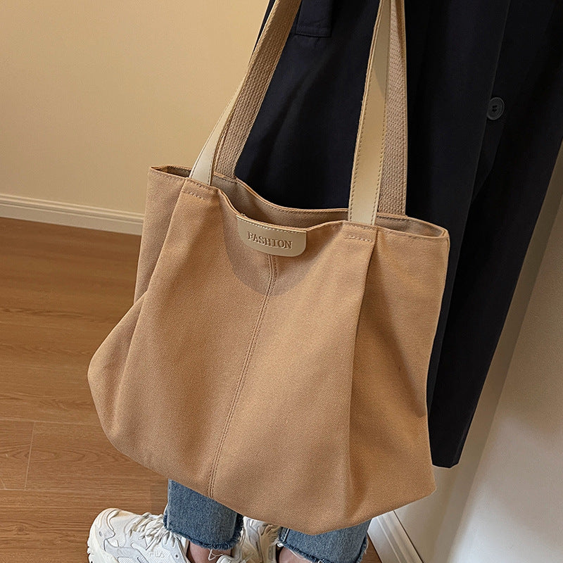 Large capacity canvas bag for women in autumn and winter 2025, fashionable and casual single shoulder handbag, student class commuting tote bag