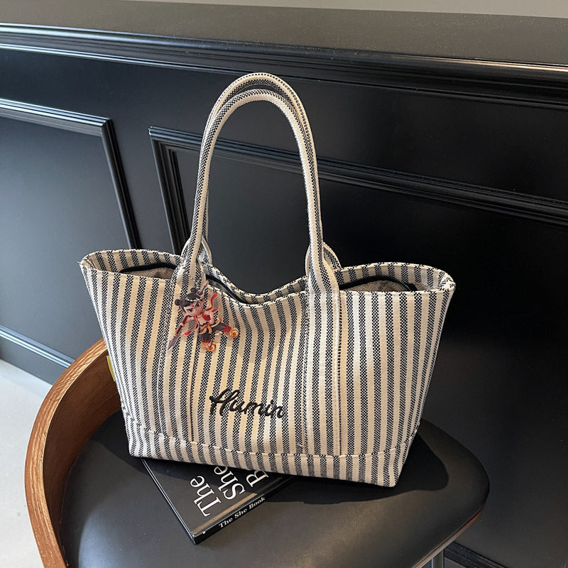 Striped canvas handbag for women in spring and summer 2025, large capacity tote bag, commuting shoulder bag, travel bag