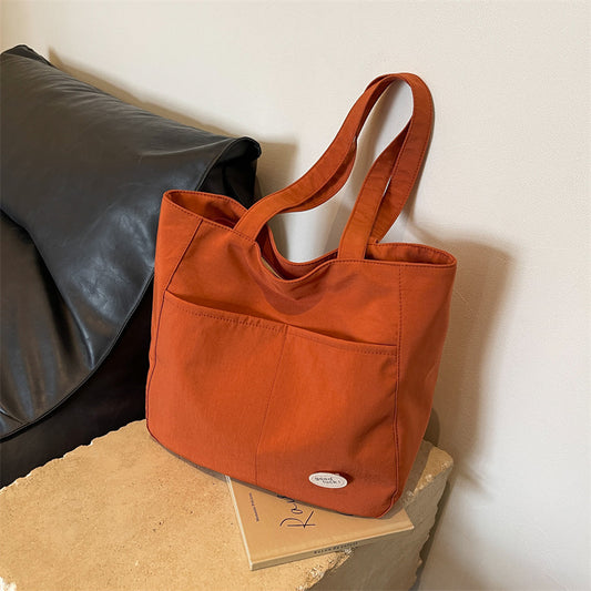 High end canvas bag for women, large capacity, new design for autumn and winter 2025, Japanese students' simple class commuting shoulder bag