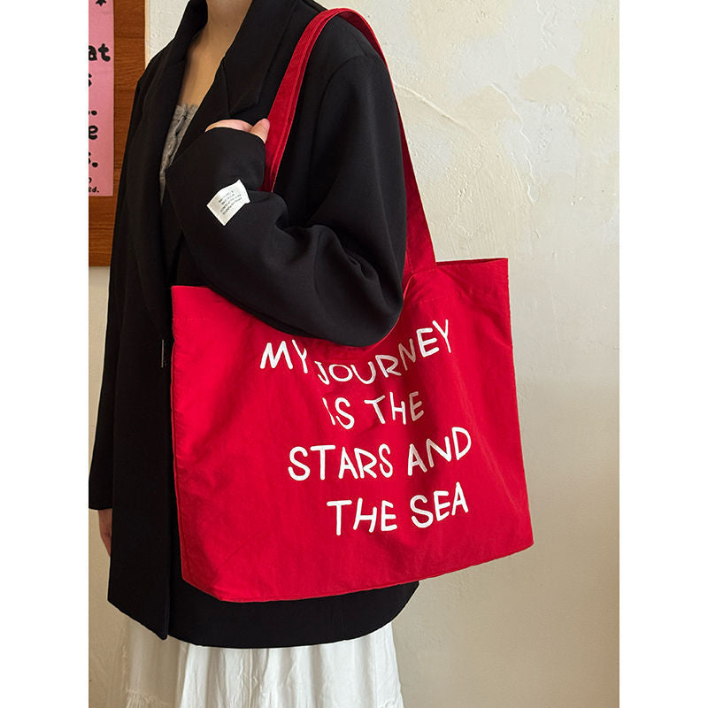 2025 new autumn and winter large capacity canvas bag, women's new lazy style work commuting shoulder bag, niche versatile tote bag