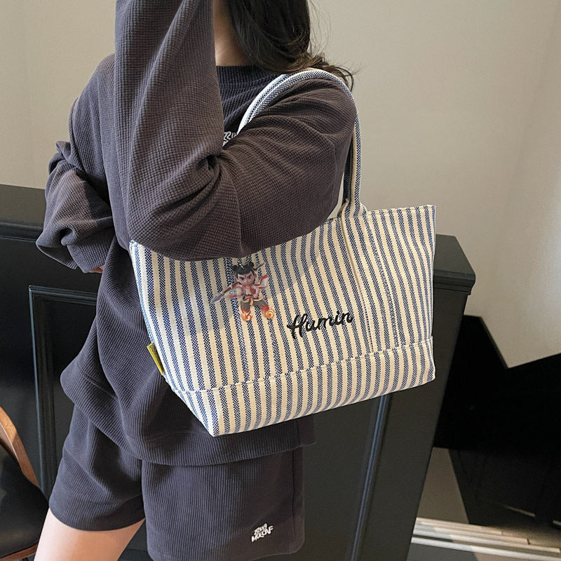Striped canvas handbag for women in spring and summer 2025, large capacity tote bag, commuting shoulder bag, travel bag