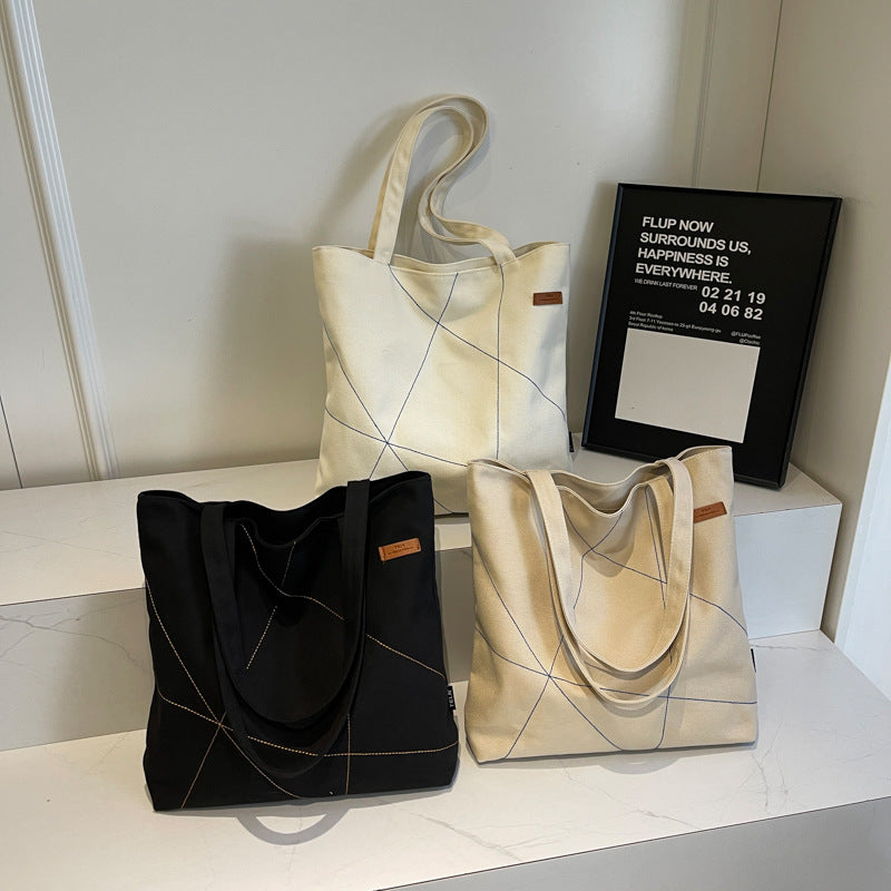 Large capacity tote bag for women in autumn 2025 with new stitching design, shoulder bag, fashionable commuting bag, versatile and trendy canvas bag