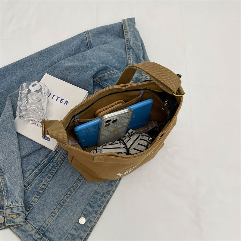 2025 new solid color letter printed canvas trendy and personalized daily simple women's bag shoulder bag crossbody bag vertical women's bag