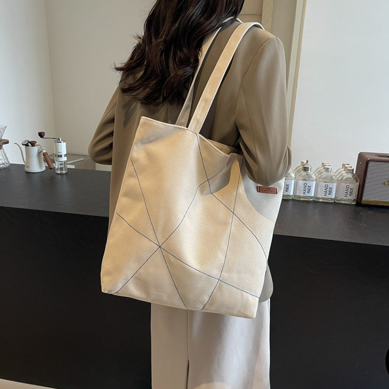 Large capacity tote bag for women in autumn 2025 with new stitching design, shoulder bag, fashionable commuting bag, versatile and trendy canvas bag