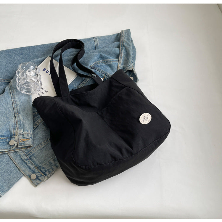 High end canvas bag for women, large capacity, new design for autumn and winter 2025, Japanese students' simple class commuting shoulder bag