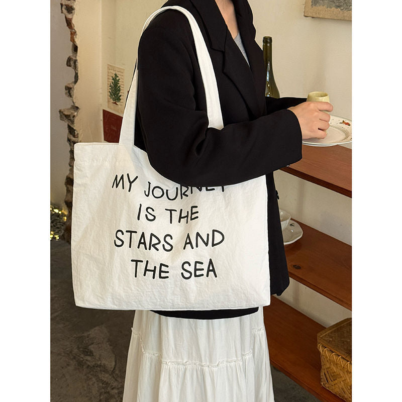 2025 new autumn and winter large capacity canvas bag, women's new lazy style work commuting shoulder bag, niche versatile tote bag