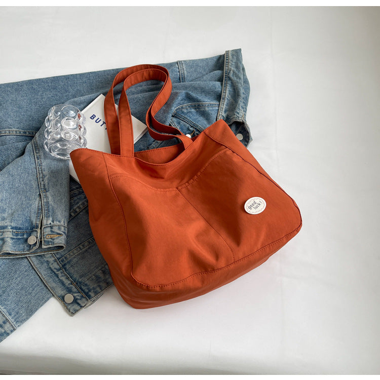 High end canvas bag for women, large capacity, new design for autumn and winter 2025, Japanese students' simple class commuting shoulder bag