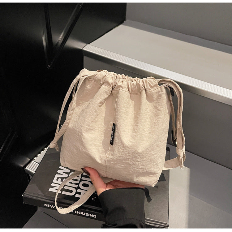 Summer casual versatile drawstring Oxford cloth bucket bag, women's 2025 new niche artistic crossbody bag, mobile phone bag