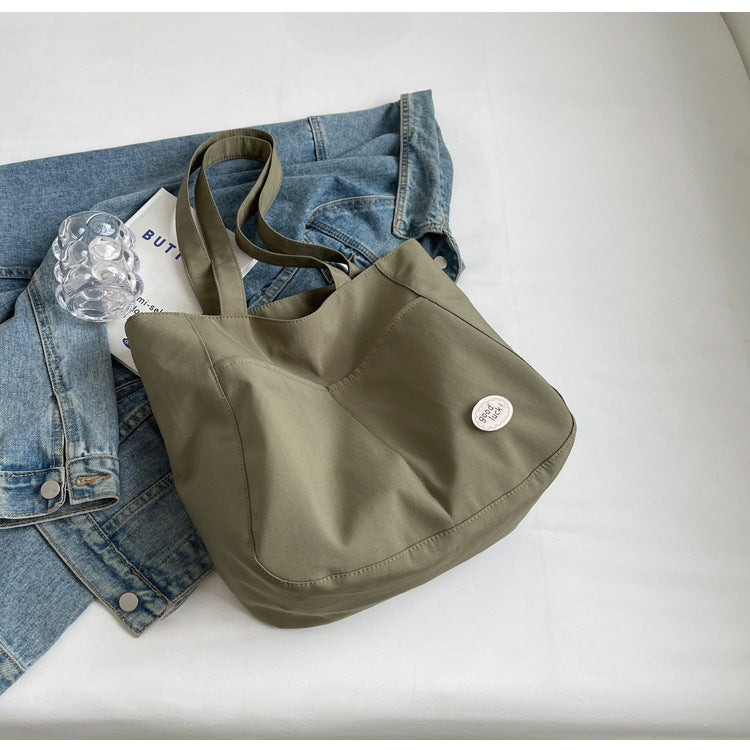 High end canvas bag for women, large capacity, new design for autumn and winter 2025, Japanese students' simple class commuting shoulder bag